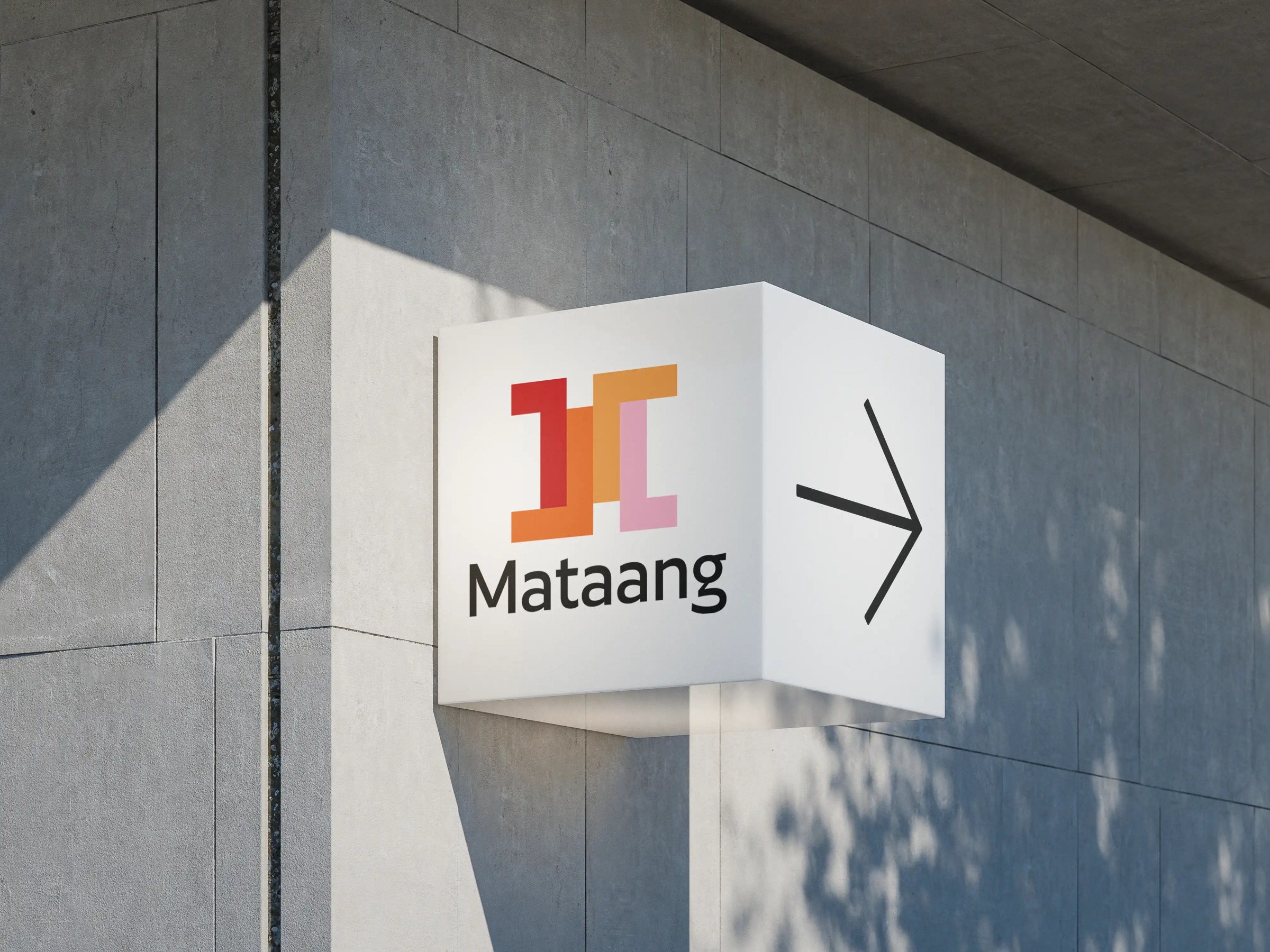 Mataang logo and wordmark on a projecting architectural sign, with a directional arrow.