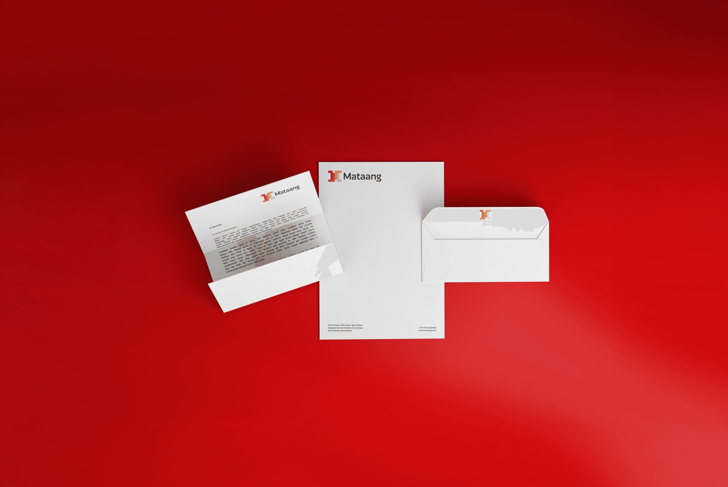 Mataang letterhead, business cards and envelope arranged on a red background.