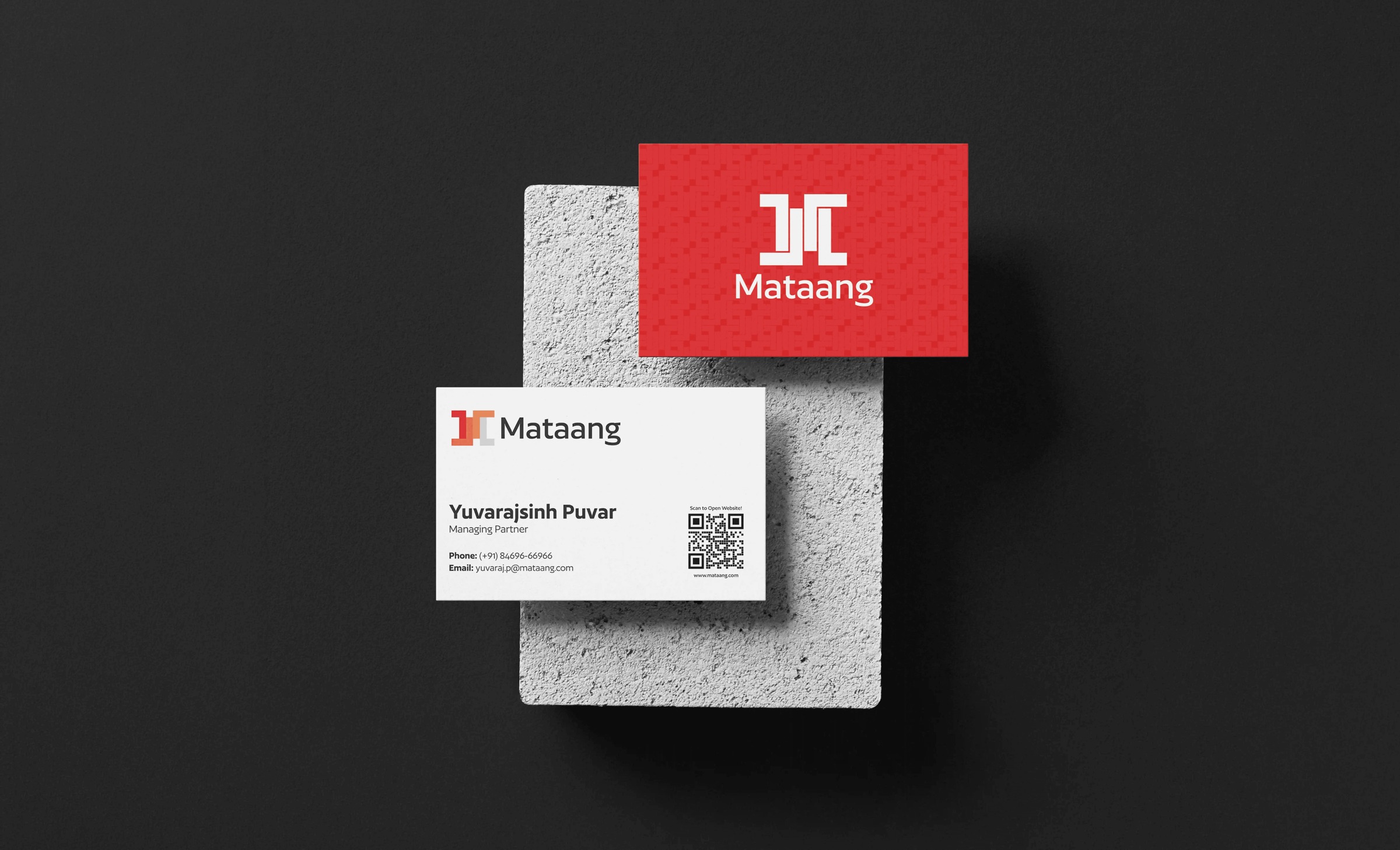 Red and white Mataang business cards displayed on textured blocks.